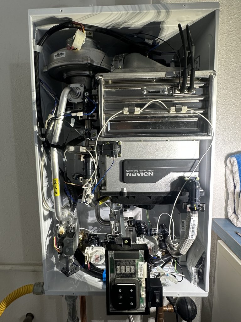 Internal components of a Navien NPE-240A2 tankless water heater taken during professional service inspection