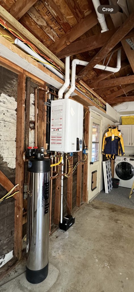 Navien tankless water heater and Pura-Flo descalePLUS salt-free water conditioner installed in garage in Rancho Santa Fe home